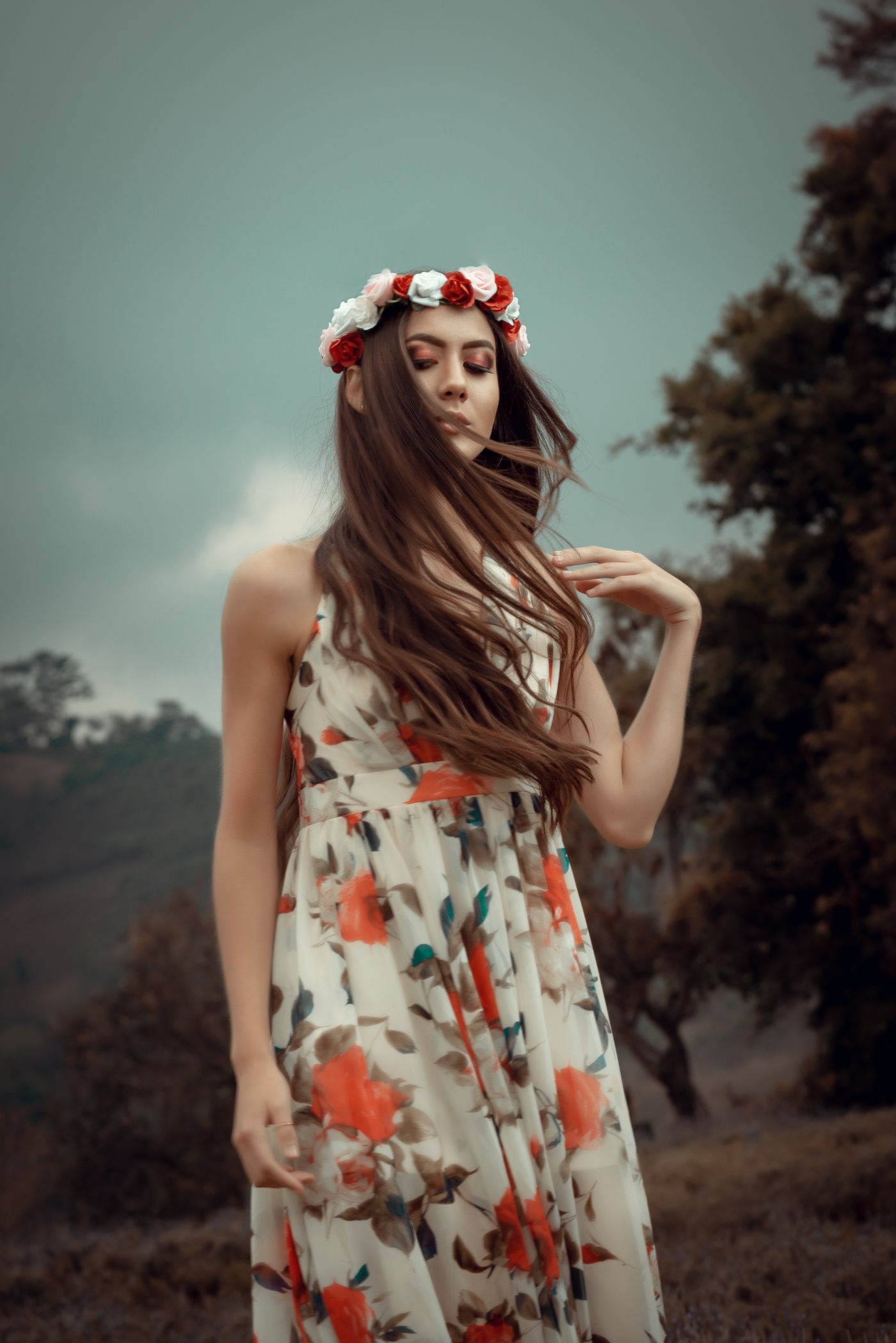 Woman in a strapless floral dress with a flower headband.
