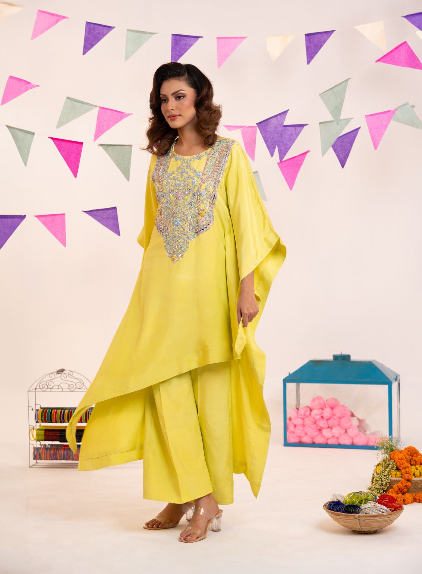 Woman wearing a yellow tunic and wide palazzo trousers.